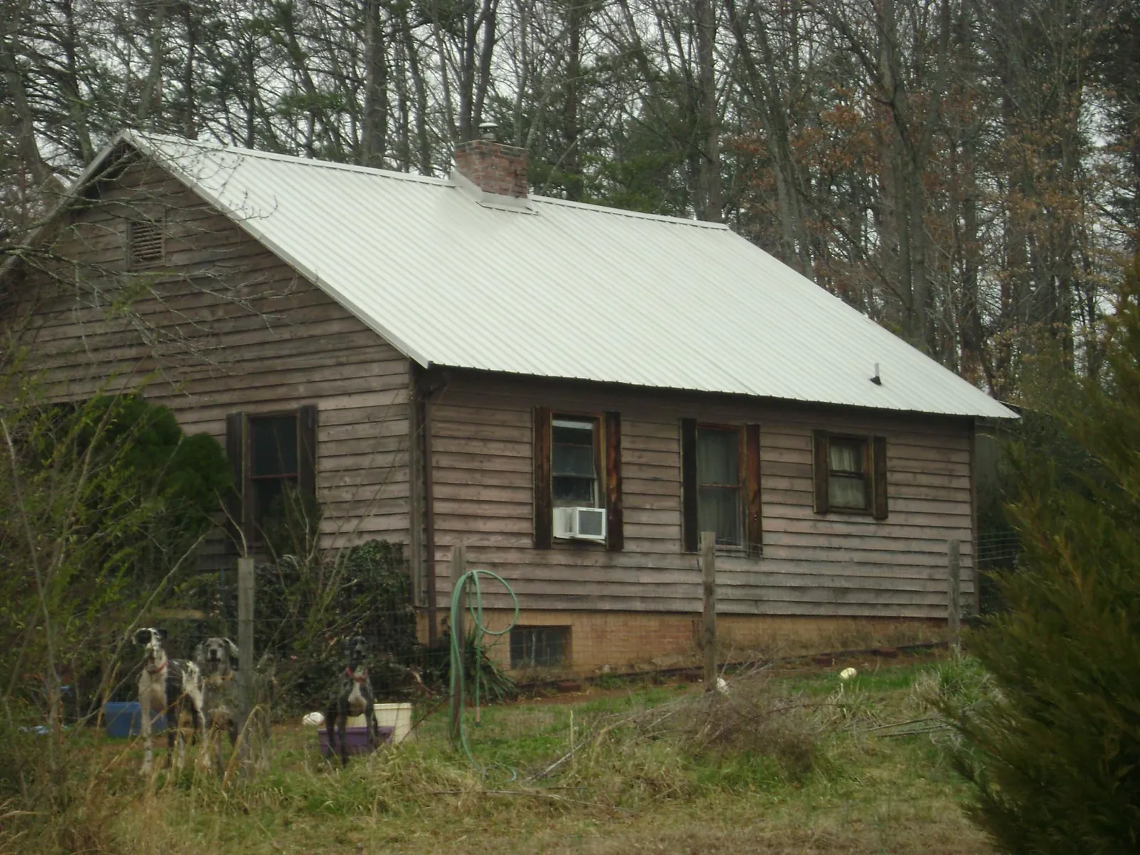 White metal roof on an old wood sided farmhouse, from a Metal Roof Installation job in Glen Flora